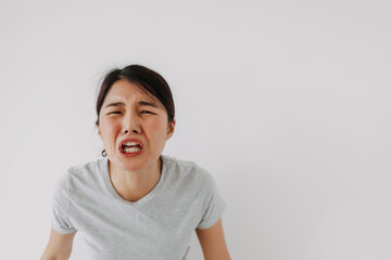 Asian woman crying funny face, sad and disappointed, standing isolated over white background wall.