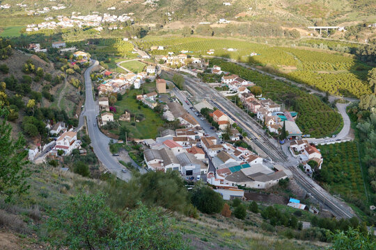 View of Barriada quarter of the Andalusian town of Alora , with its railway station, in the shadow of the castle hill. 