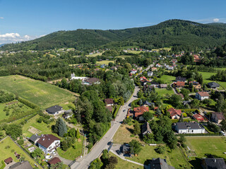 Drone view in Beskid mountains. Beskid mountains in Jaworze.  Summer green forest in Jaworze. Drone fly above green mountains in summer. Polish green mountains and hills aerial drone photo