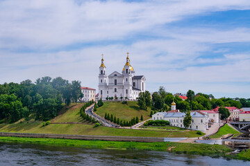 Vitebsk,Belarus - JUNE 20, 2024: Holy Assumption Cathedral of the Assumption on the hill and the Holy Spirit convent and Western Dvina River. Vitebsk, Belarus