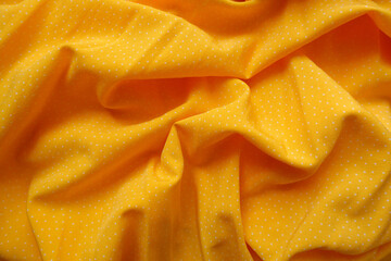 Crumpled amber yellow viscose fabric with white pin dot pattern