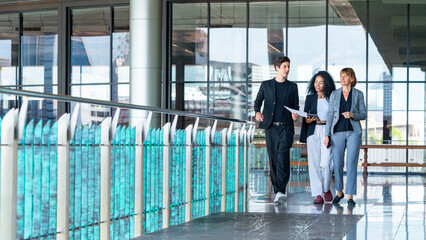 Group of Diversity businessman and businesswoman colleague working and discussion business project together outside office building. Business people teamwork meeting corporate business in the city.