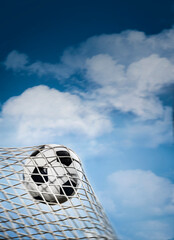 soccer ball in a net and a blue sky