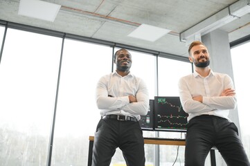 Two diverse crypto traders brokers stock exchange market investors discussing trading charts research reports growth using pc computer looking at screen analyzing invest strategy, financial risks