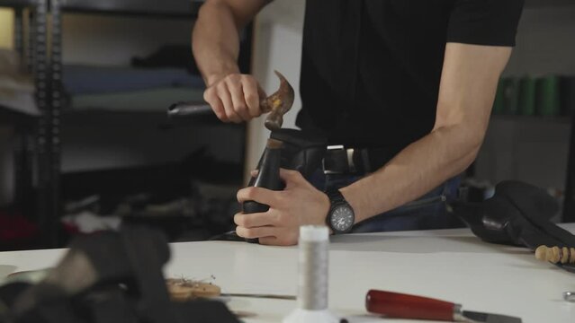 A shoemaker in the process of repairing shoes