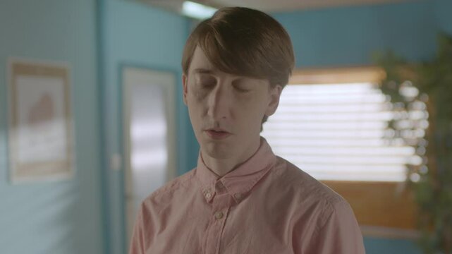 Nerdy looking Man Standing in a Modern Office looking Bored, Static Mid Shot