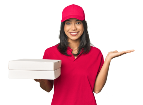 Latina delivering pizza, studio setup showing a copy space on a palm and holding another hand on waist.
