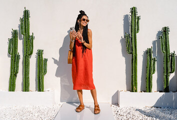 stylish pretty woman with african braids on sunny summer vacation