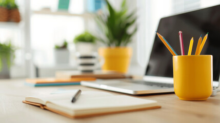 'well-organized study desk in a home, laptop, open notebook, and a cup of pencils' 