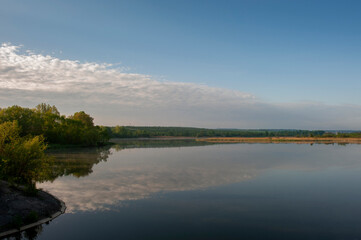 Fototapeta premium Beautiful panorama of autumn lake against the background of forest and sunny sky