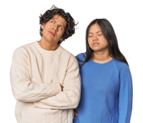 Young interracial couple in studio tired of a repetitive task.