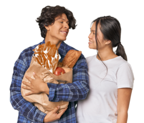 Multiracial young couple shopping for groceries in studio