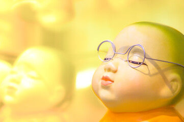 Statue of a novice wearing glasses