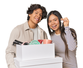 Multiracial young couple with moving boxes in studio