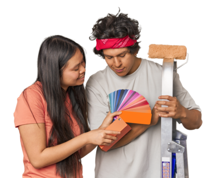 Happy multiracial couple with painting tools in studio