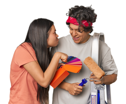 Happy multiracial couple with painting tools in studio