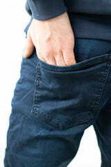 hand inside the back pocket of jeans