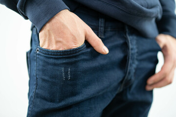 hand inside the pocket of jeans