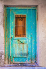 Ancient blue door on the street in Crete, Greece
