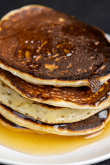 soft fresh pancakes and natural liquid honey in a wooden bowl