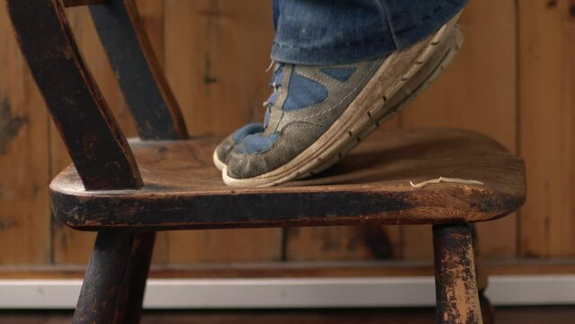 Feet standing on stool on tip toes 