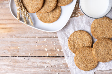Healthy oatmeal cookies and milks on wooden table. Top view. Copy space
