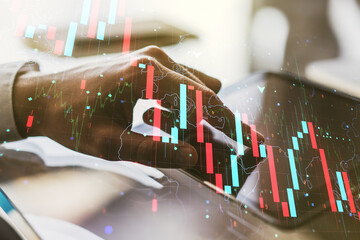 Creative abstract economic crisis chart with world map hologram and with finger presses on a digital tablet on background, bankruptcy and recession concept. Multiexposure
