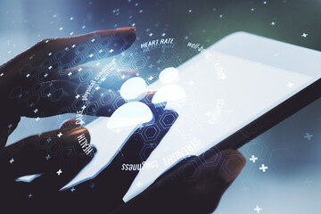 Creative abstract people icons hologram and finger presses on a digital tablet on background, life and health insurance concept. Multi exposure