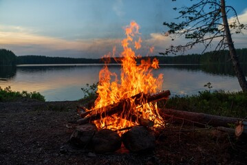 Campfire by the lake at sunset.