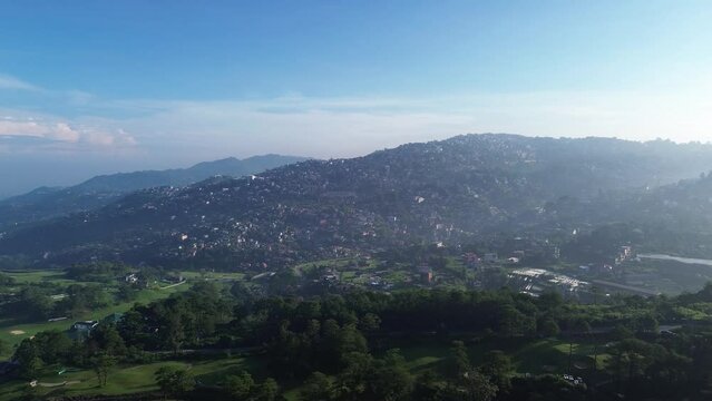 Disorderly housing community in the rugged terrain of a mountainous city. Drone aerial tracking shot
