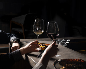 Couple enjoys romantic evening with wine and meal at dimly lit restaurant