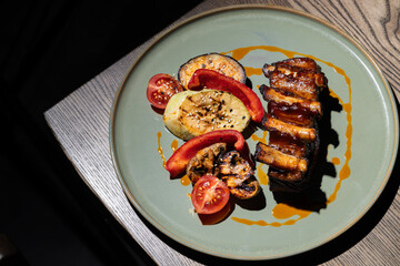 grilled pork ribs with tomato and zucchini