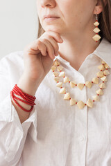 Lutsk, Ukraine - May 16 2024: A girl with a red beaded bracelet and straw necklace