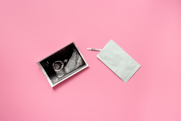 Pregnancy test with Ultrasound image of a baby. Pregnancy and conceiving a child concept