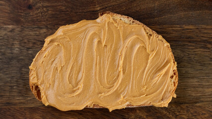 Sandwiches with Peanut Butter. Peanut Butter Spreading on bread with a knife, close up