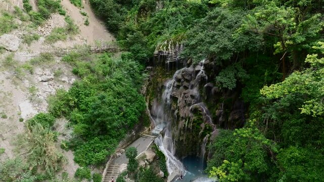 La Gloria waterfall and the Mezquital Canyon at Grutas Tolantongo, Mexico. Fast approaching descending drone flight