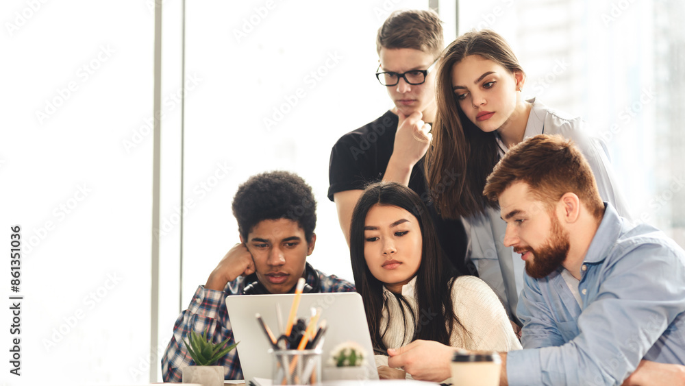 Aufkleber Remote education. A collaborative scene unfolds in the library where multiracial students use various devices to study. The environment is calm, with a focus on shared knowledge and technology.