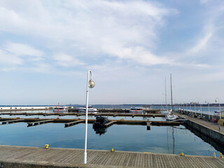 Yacht club and marina long view. Luxurious yacht marina. Yacht parking in harbor, harbor yacht club Beautiful Yachts in blue sky background. High quality photo