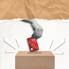 A human hand gives a credit card to a donation box