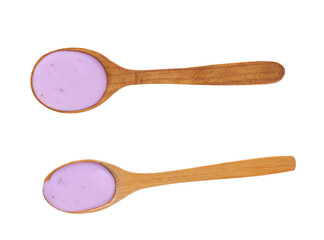 Wooden spoon with blueberry yogurt isolated on a white background. Top view.