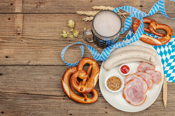 Traditional Oktoberfest set. Pretzels, beer, weisswurst, eisbein with mustard. German festival food