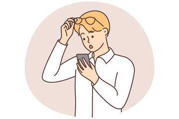 Stunned man shocked with message on cell