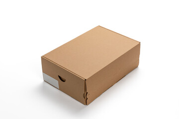 Cardboard box with a white label on top. cardboard box on a white background.