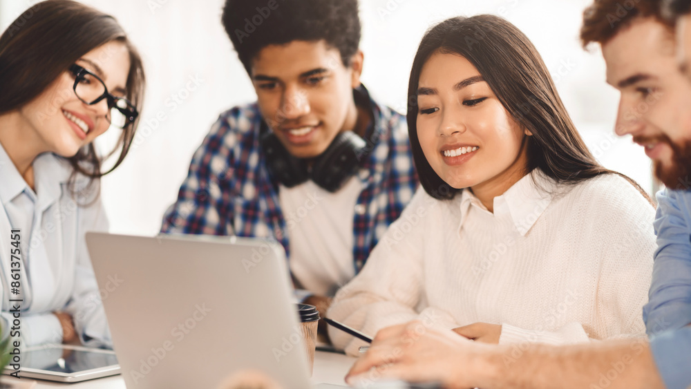 Aufkleber Multiethnic students leverage technology for learning in the library, each absorbed in their device. The setting is serene, promoting a studious atmosphere.