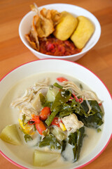 Indonesian sundanese traditional food, sayur lodeh, fried salted fish or ikan asin goreng with fried tofu and tempeh.