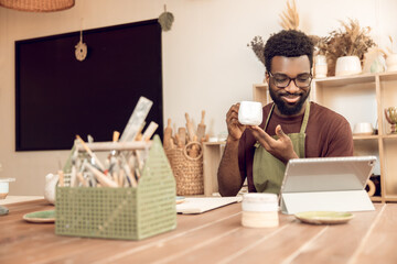 African american sculptor conducting a n online tutorial and looking contented