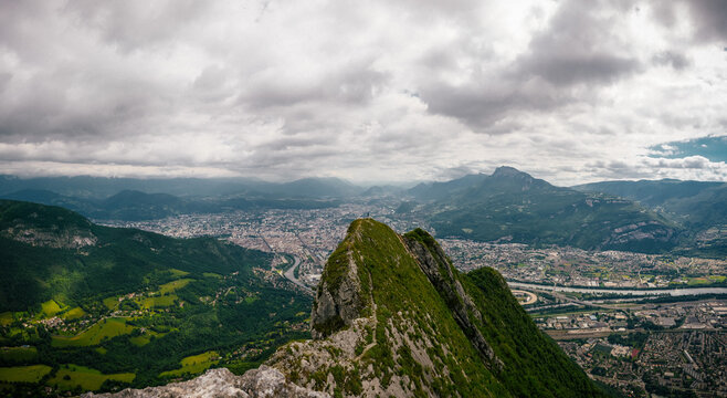 landscape with clouds, person on mountain and city, panorama, France, Grenoble, La Neron