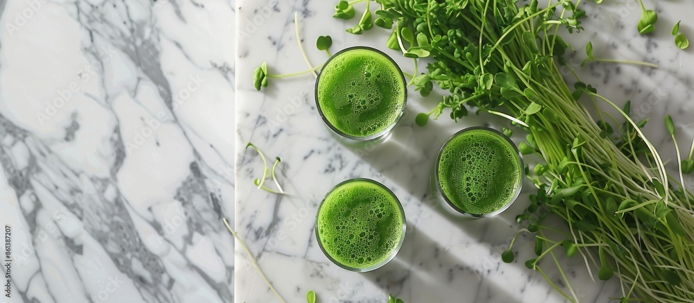 Poster a marble table showcasing glasses of wheatgrass juice with green sprouts, offering ample room for te