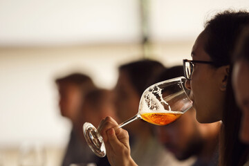 Professional Female Sommelier -Representative of Alcohol Company Tasting Beer from Special...