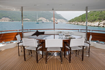 Laid table. Deck. Luxury yacht. Motorboat at Mediterranean Sea. Coast of Turkey. Luxury life.